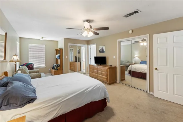 a bedroom with a bed and ceiling fan