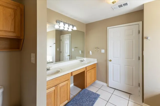a spacious bathroom with a granite countertop sink a mirror and a shower