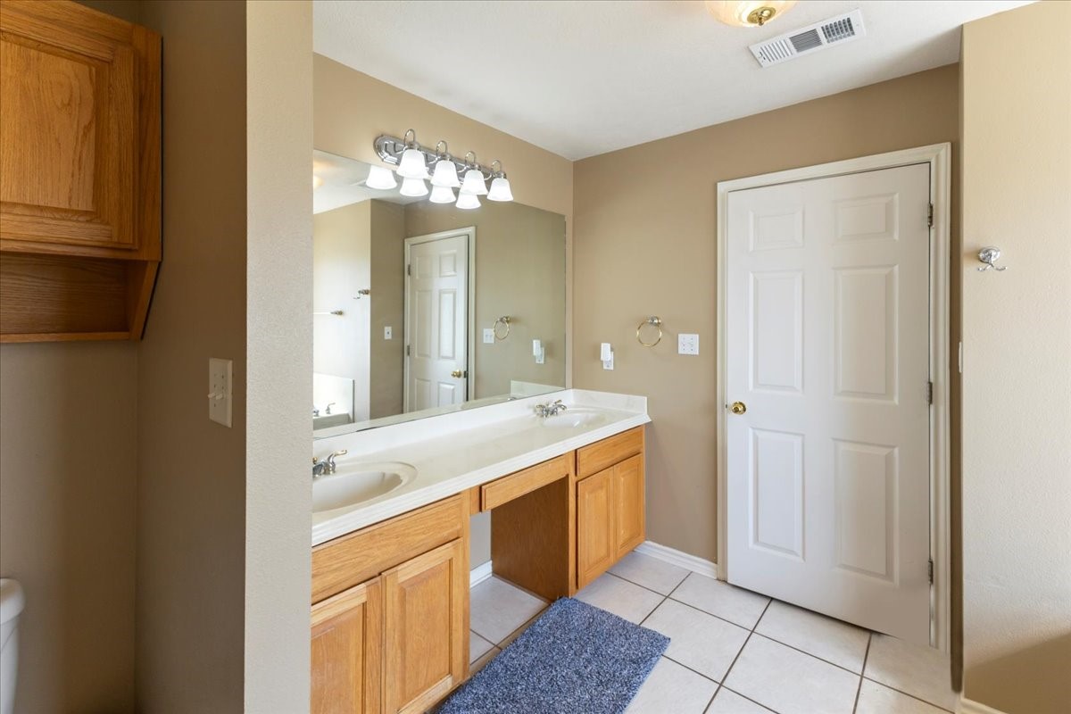 544 Meadow Lane Winnie, TX 77665 - Photo 28 of 38 a spacious bathroom with a granite countertop sink a mirror and a shower