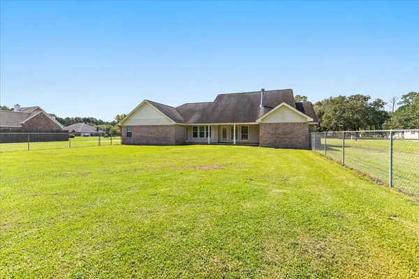 a view of a house with a swimming pool and a yard