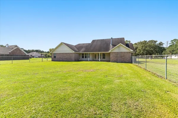 a view of a house with a swimming pool and a yard