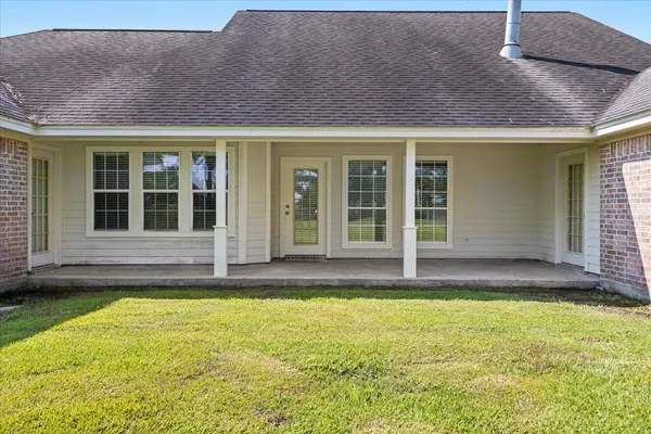 a view of a house with pool and sitting area