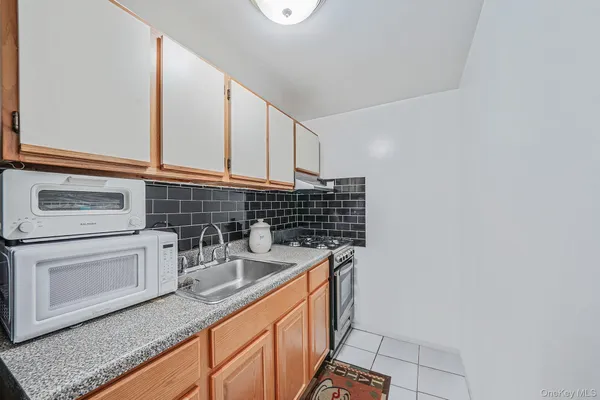 a kitchen with stainless steel appliances a sink and cabinets