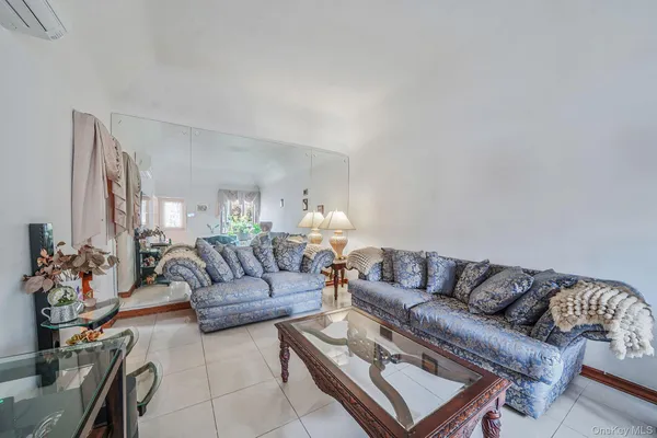 a living room with furniture and flowers