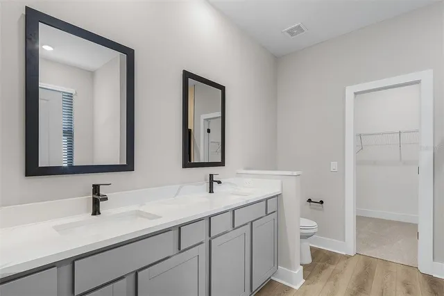 a bathroom with 2 sink and a mirror