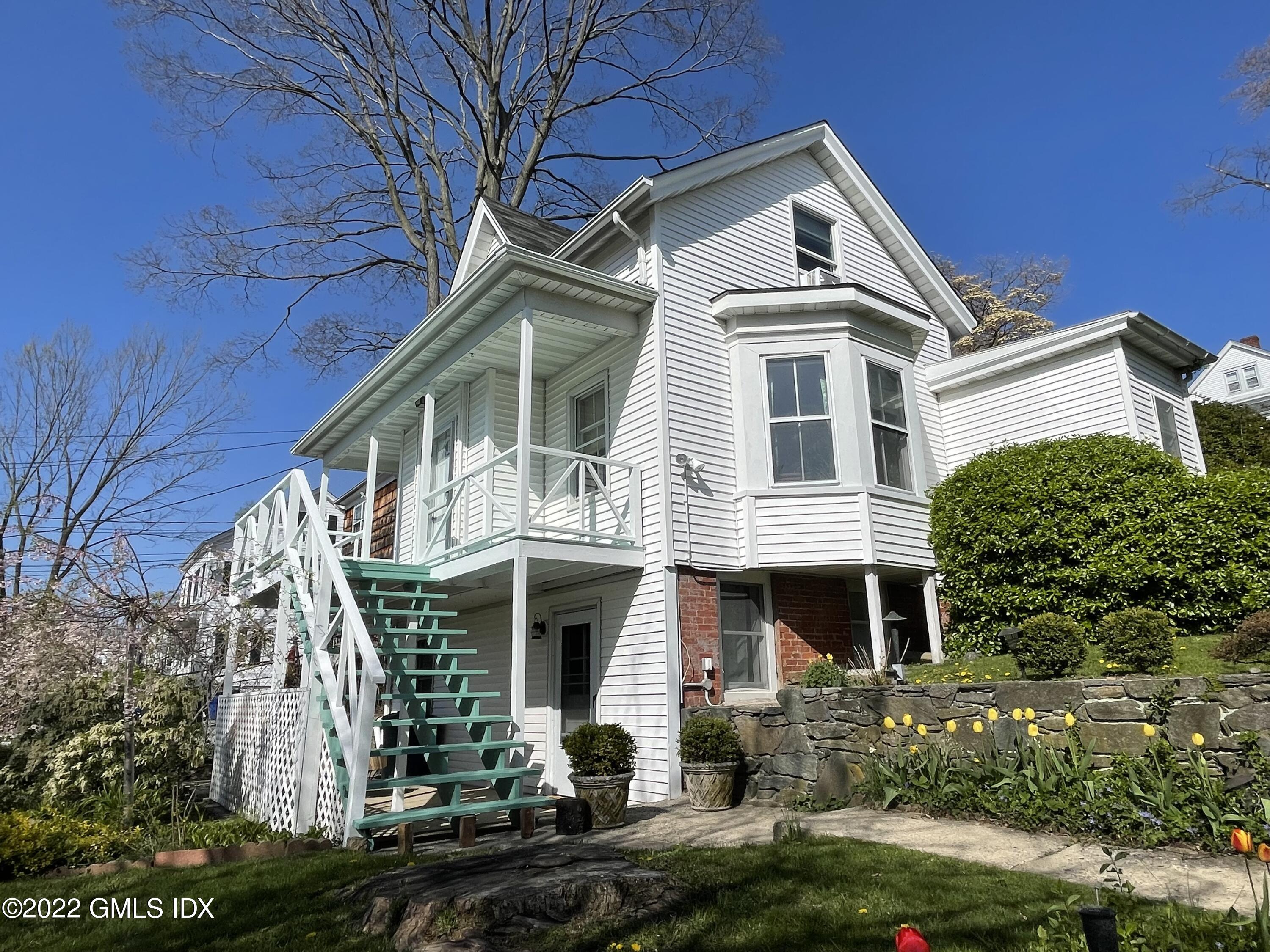 119 North Water Street Greenwich, CT 06830 - Photo 2 of 15 a front view of a house with a yard