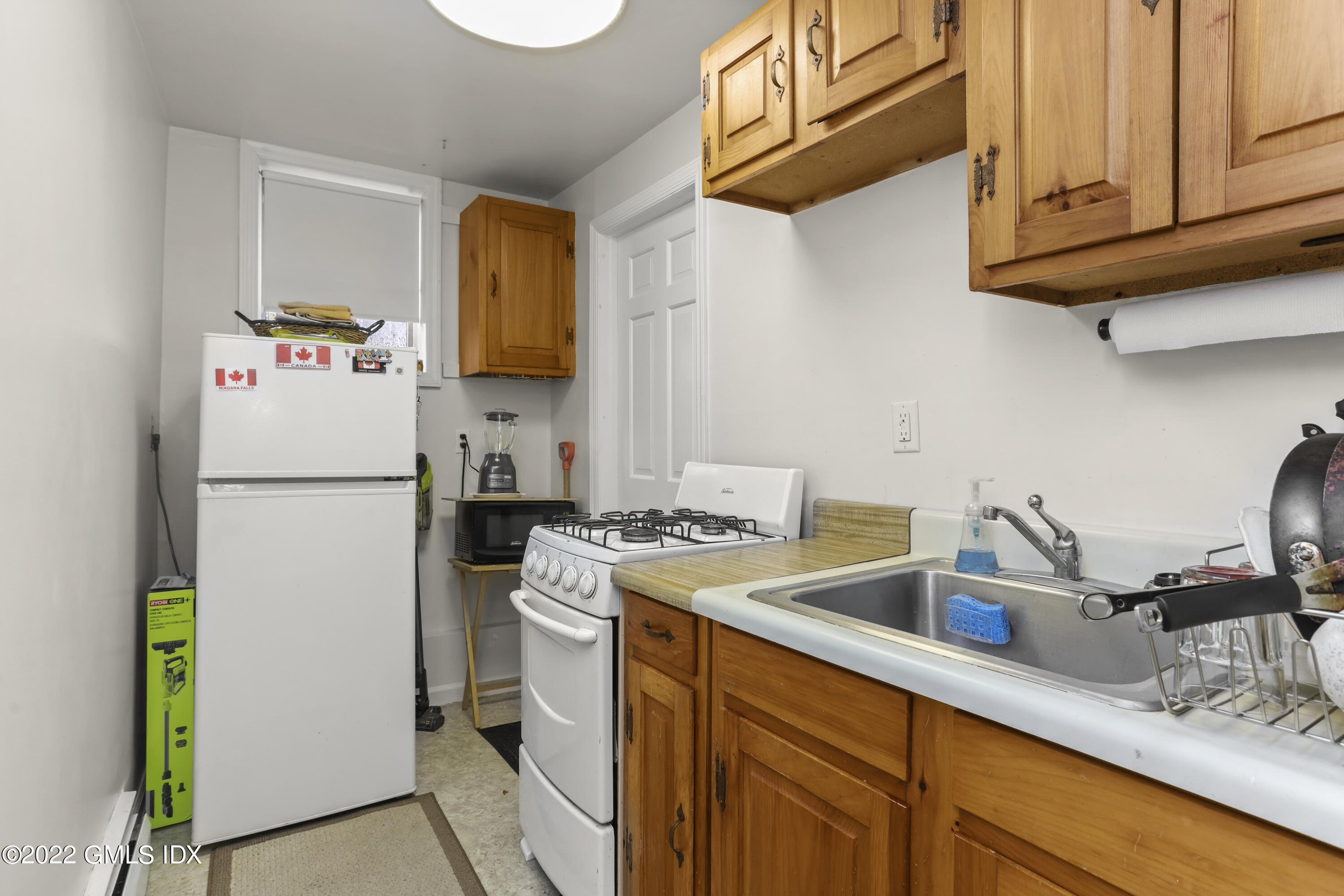 119 North Water Street Greenwich, CT 06830 - Photo 10 of 15 a kitchen with a refrigerator sink and cabinets