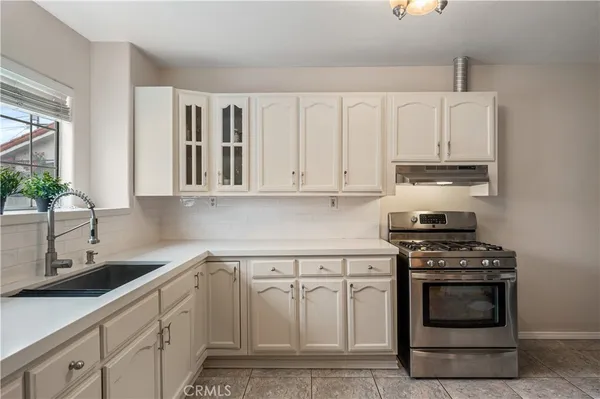 a kitchen with cabinets appliances and a sink