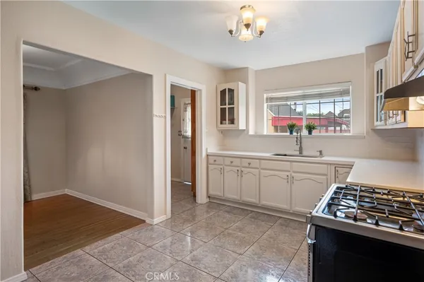 a kitchen with a sink stove and cabinets