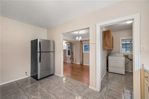 a view of a kitchen with refrigerator and an oven