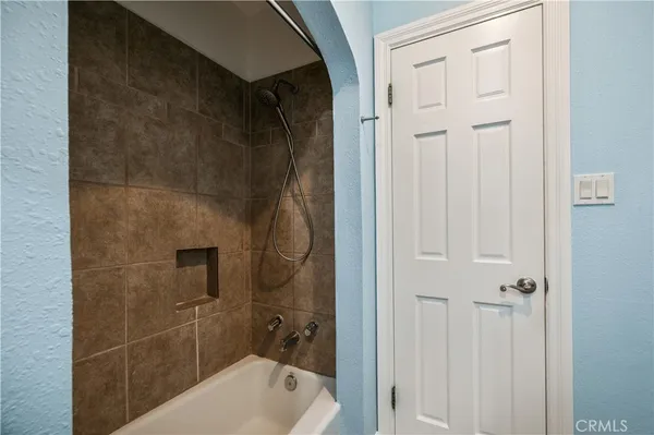 a bathroom with a tub shower vanity and a sink
