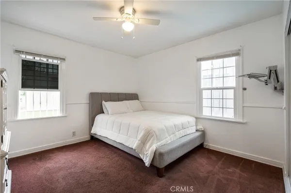 a large bed sitting in a bedroom next to a window