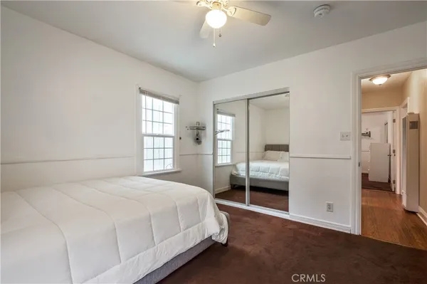 a bedroom with a bed and a large window