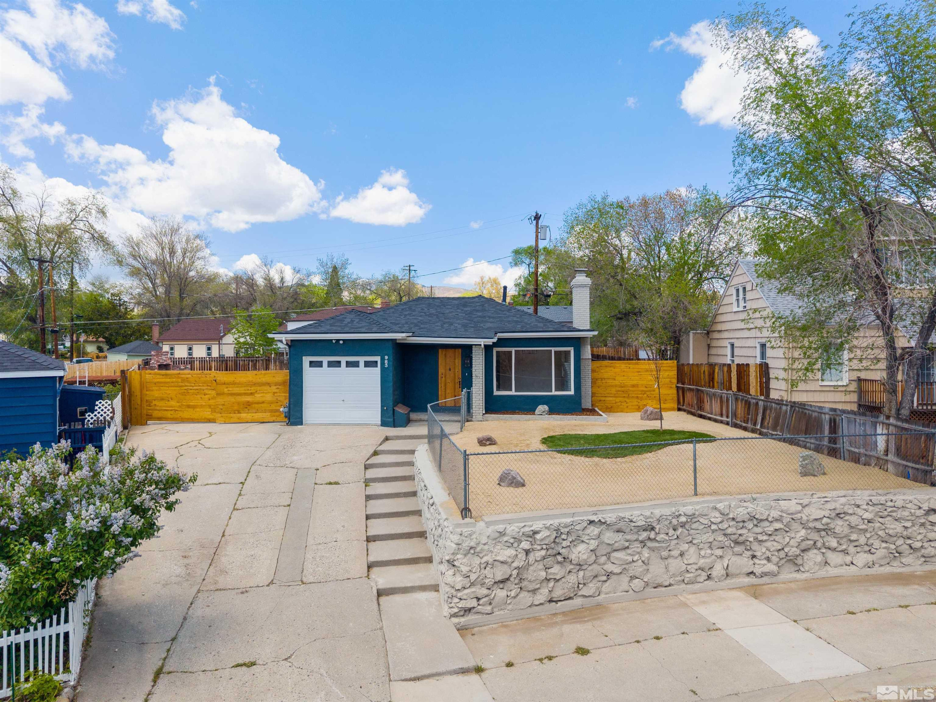 983 Melba Drive Reno, NV 89503 - Photo 1 of 39 a front view of a house with a yard and trees