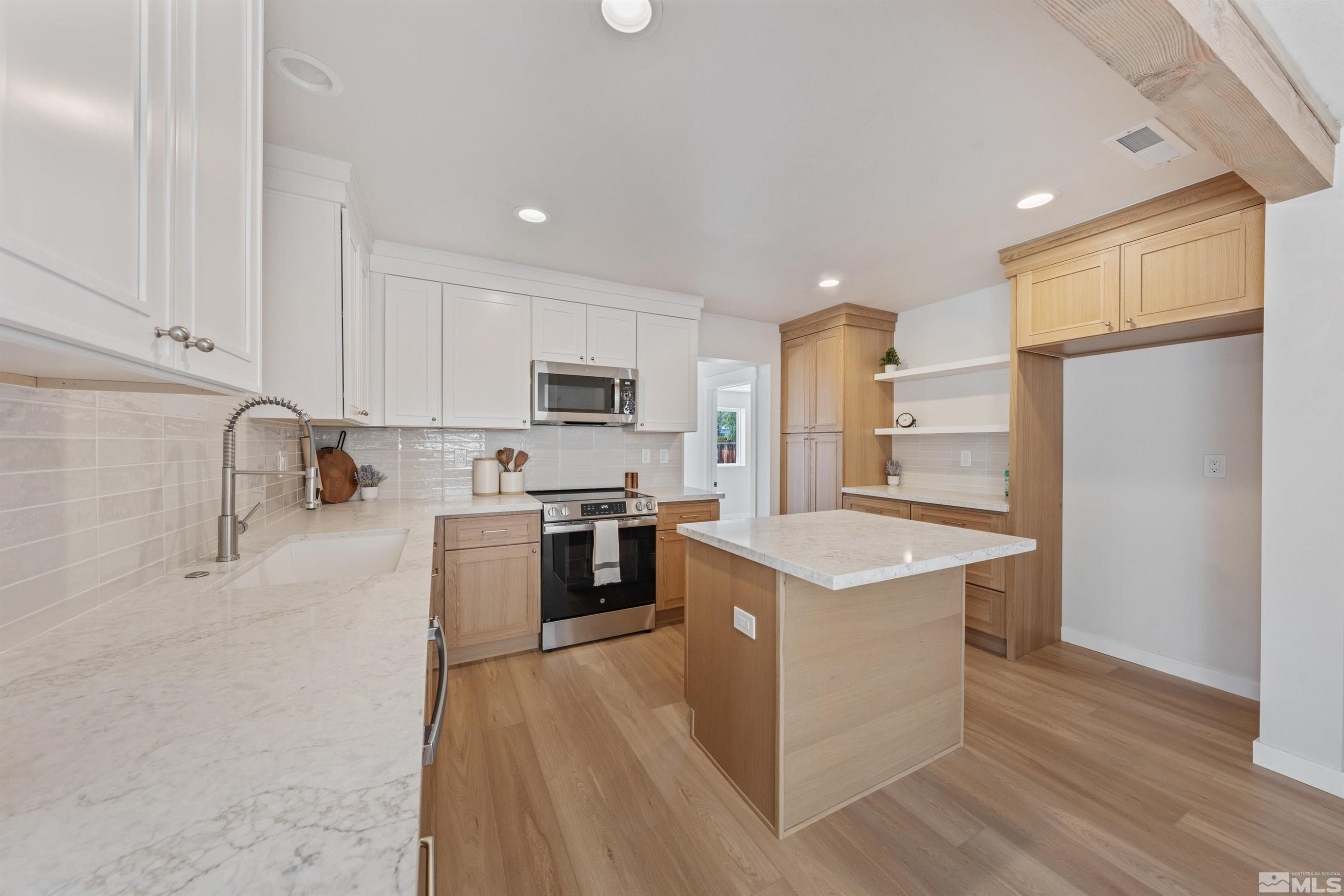 983 Melba Drive Reno, NV 89503 - Photo 11 of 39 a kitchen with a sink a counter top space stainless steel appliances and cabinets