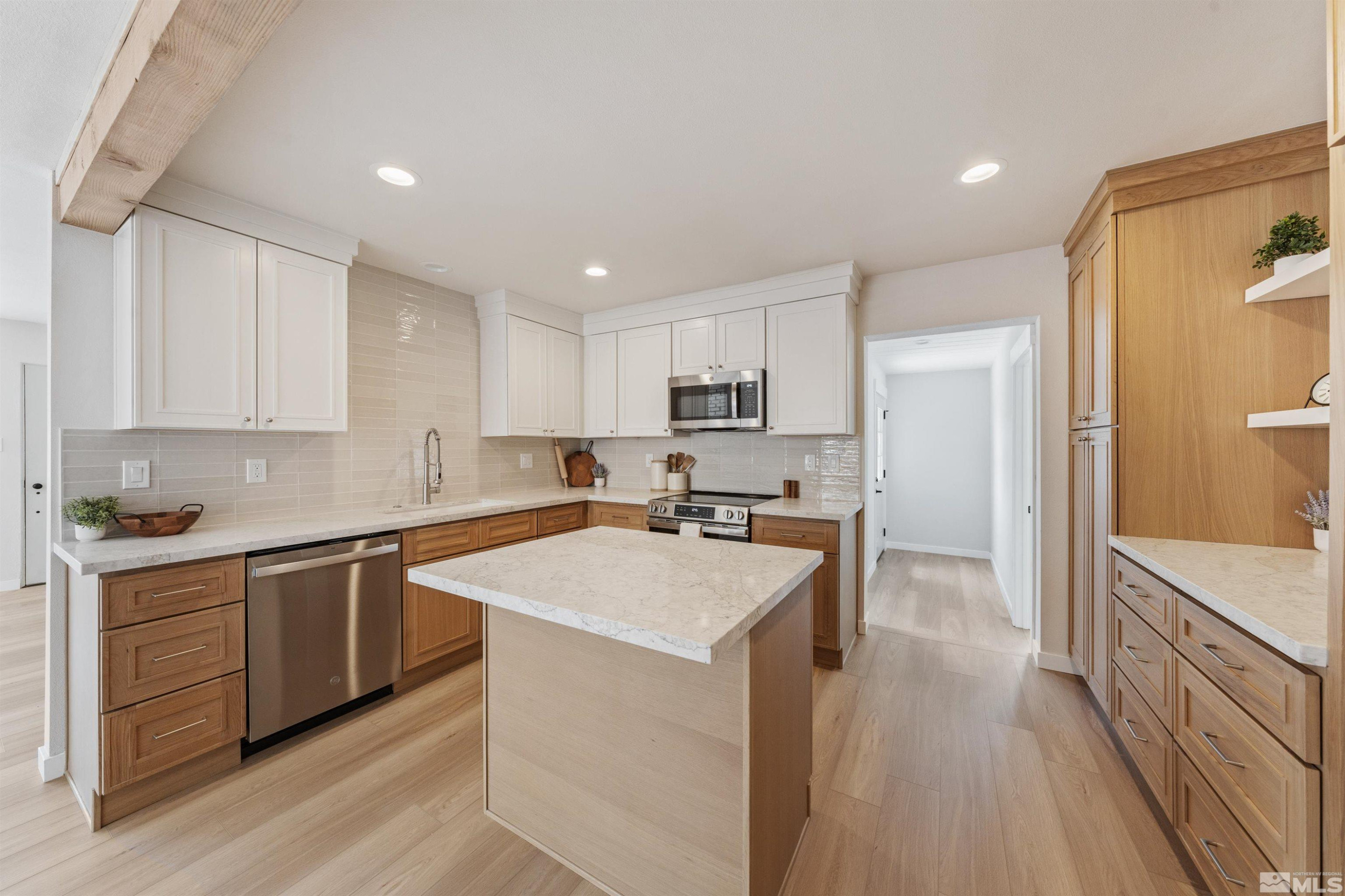 983 Melba Drive Reno, NV 89503 - Photo 12 of 39 a kitchen with a sink a counter top space stainless steel appliances and cabinets