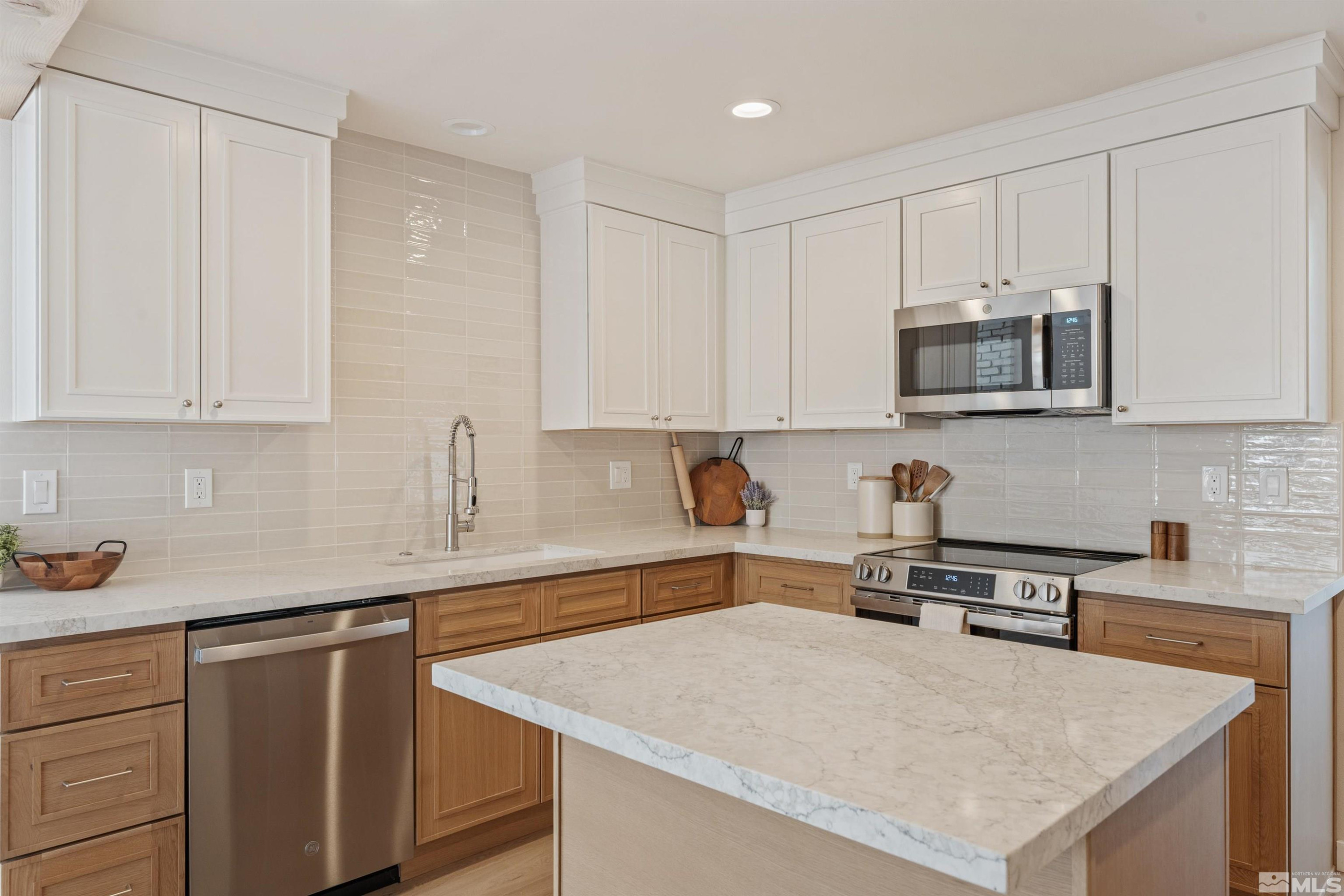 983 Melba Drive Reno, NV 89503 - Photo 13 of 39 a kitchen with stainless steel appliances granite countertop a sink a stove and microwave