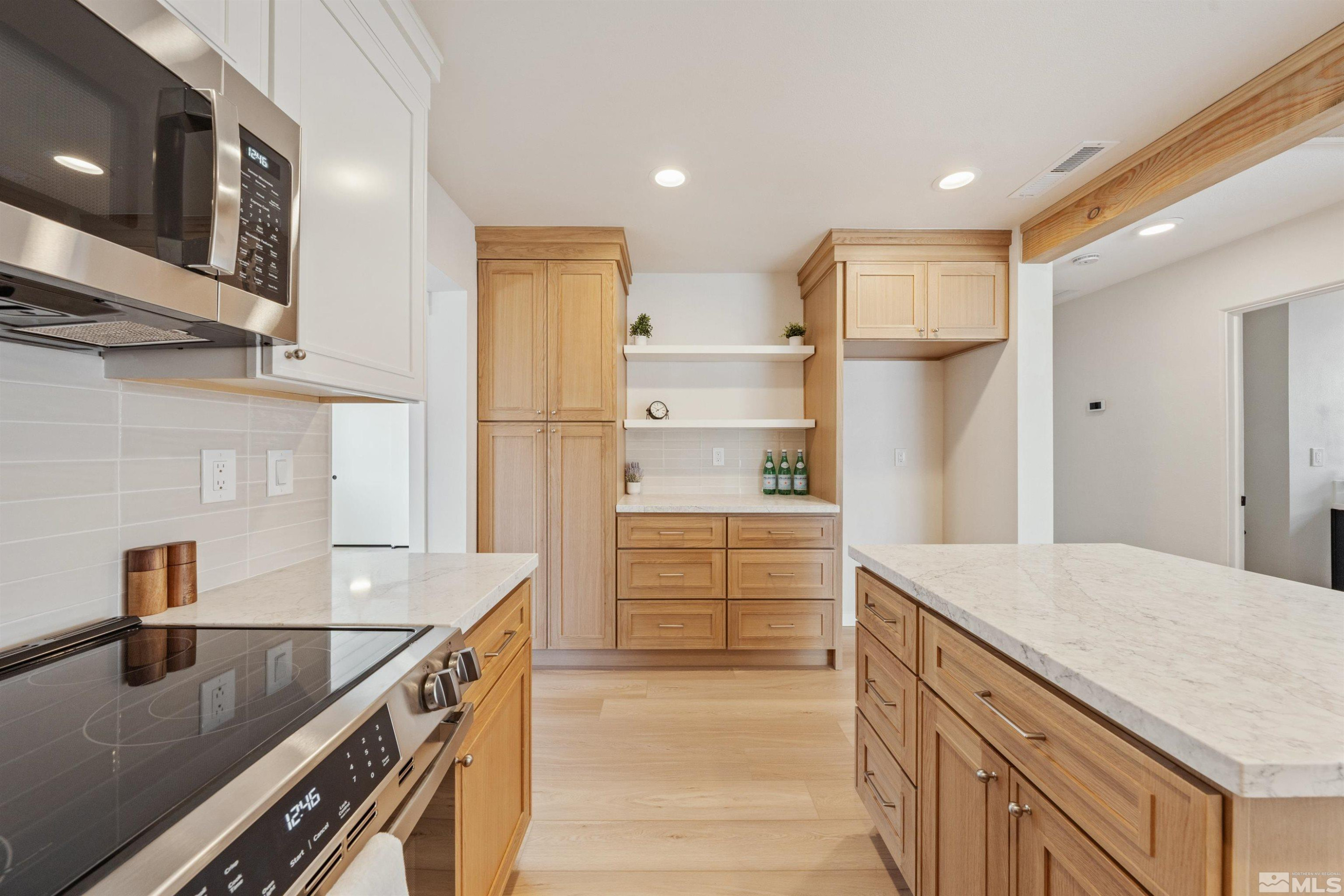 983 Melba Drive Reno, NV 89503 - Photo 14 of 39 a kitchen with kitchen island a sink appliances and cabinets