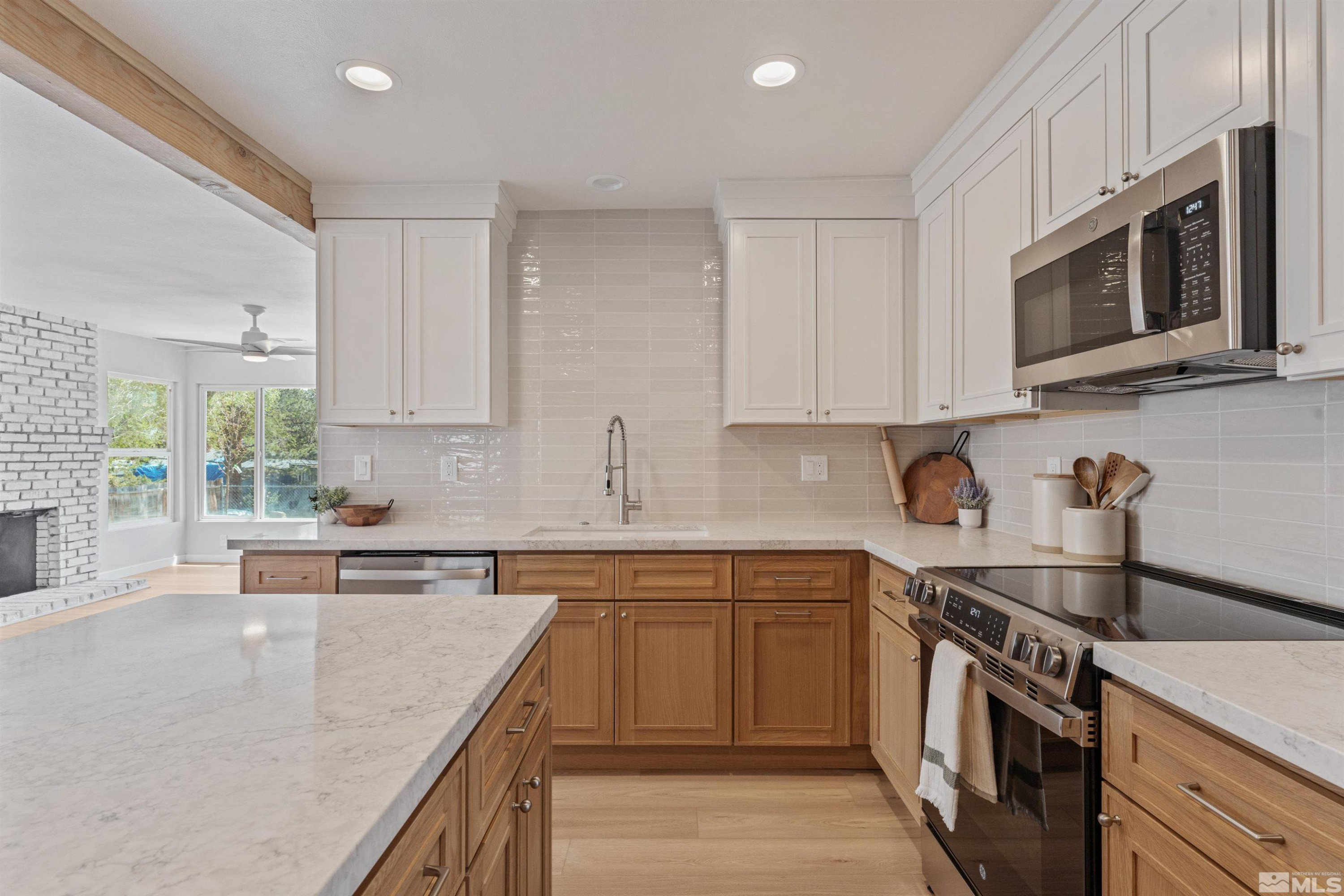 983 Melba Drive Reno, NV 89503 - Photo 2 of 39 a kitchen with stainless steel appliances granite countertop a sink stove and microwave
