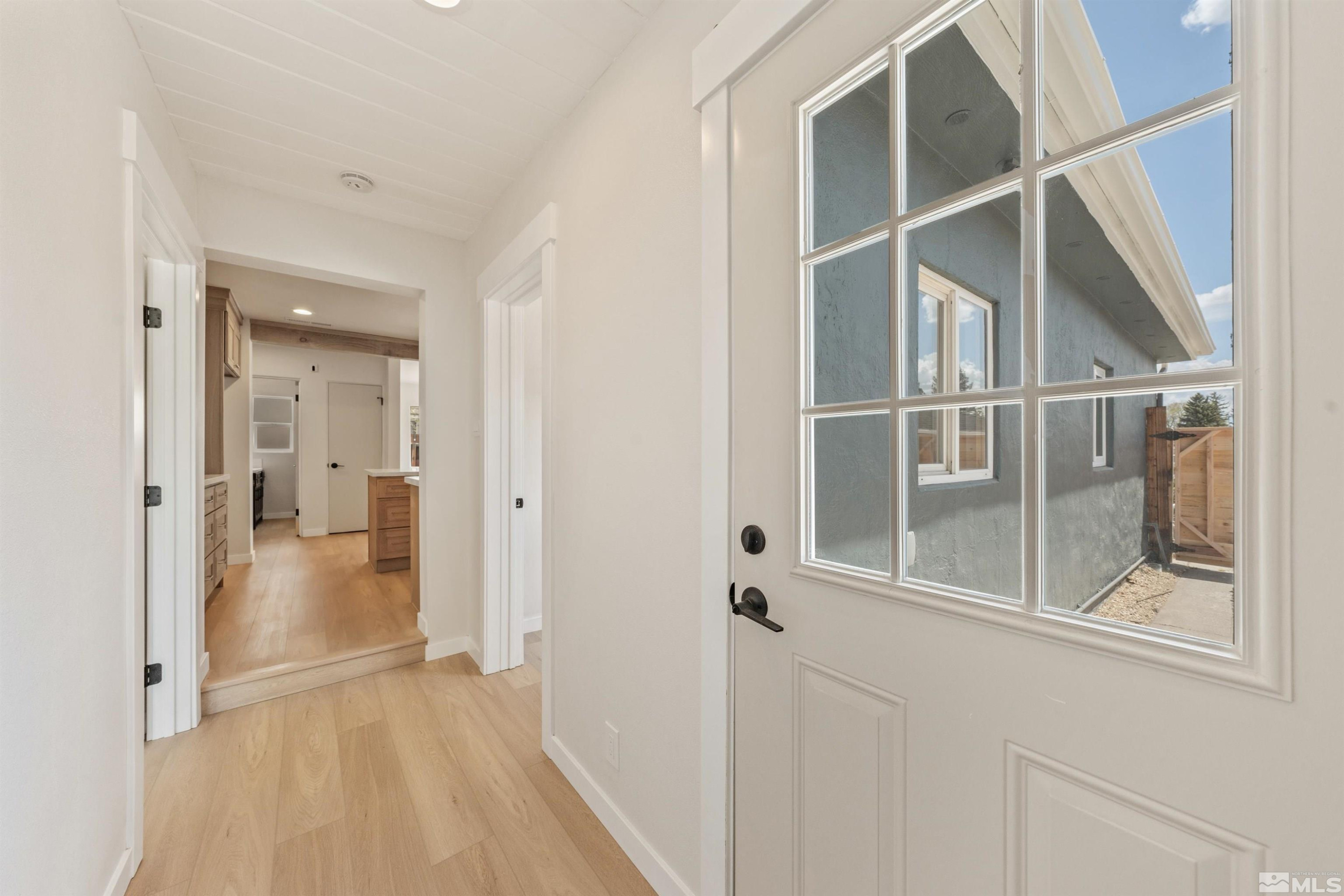 983 Melba Drive Reno, NV 89503 - Photo 27 of 39 a view of a hallway with wooden floor and entryway