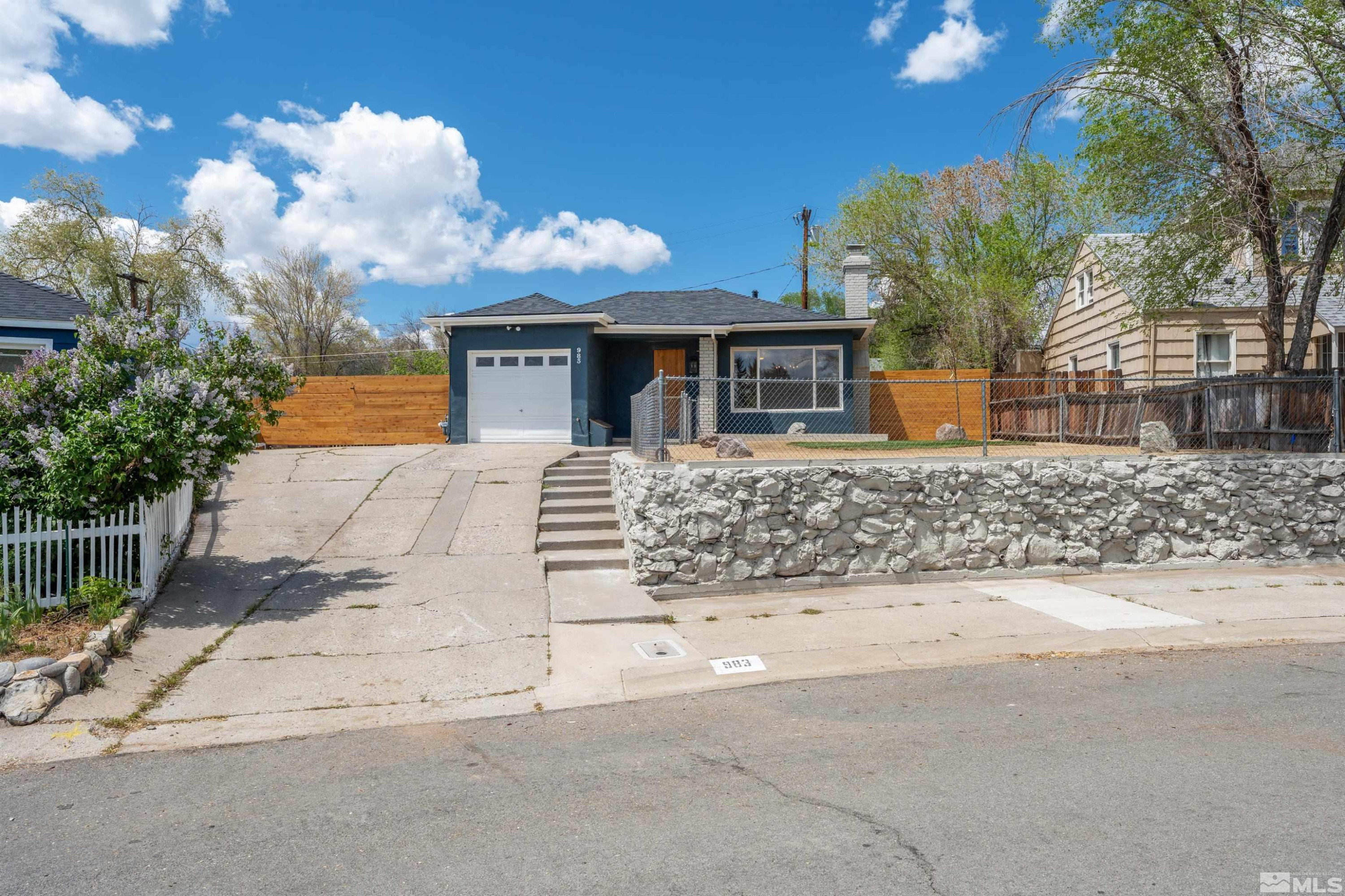 983 Melba Drive Reno, NV 89503 - Photo 39 of 39 a front view of a house with a yard and garage