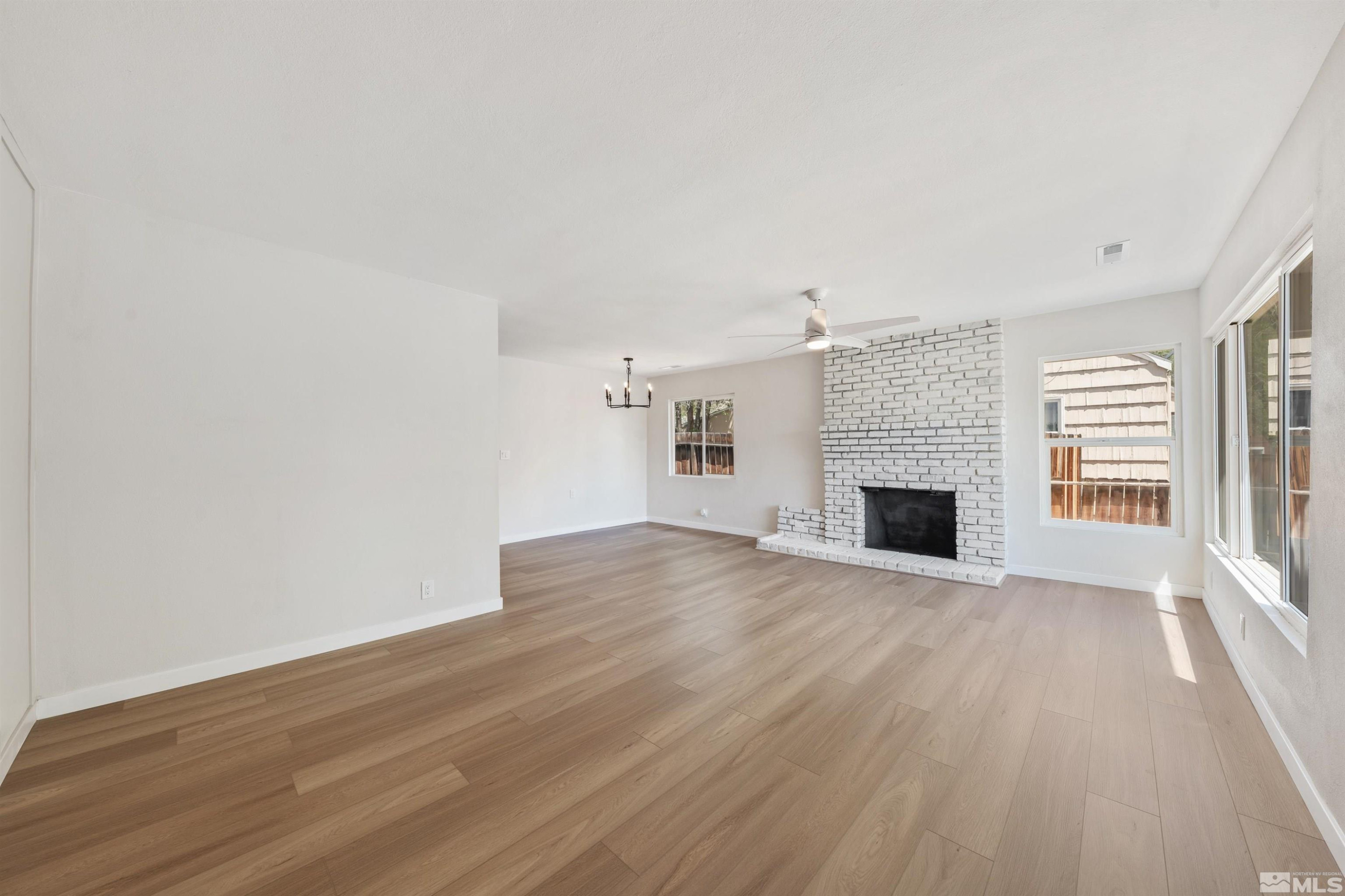 983 Melba Drive Reno, NV 89503 - Photo 6 of 39 a view of empty room with wooden floor and fireplace