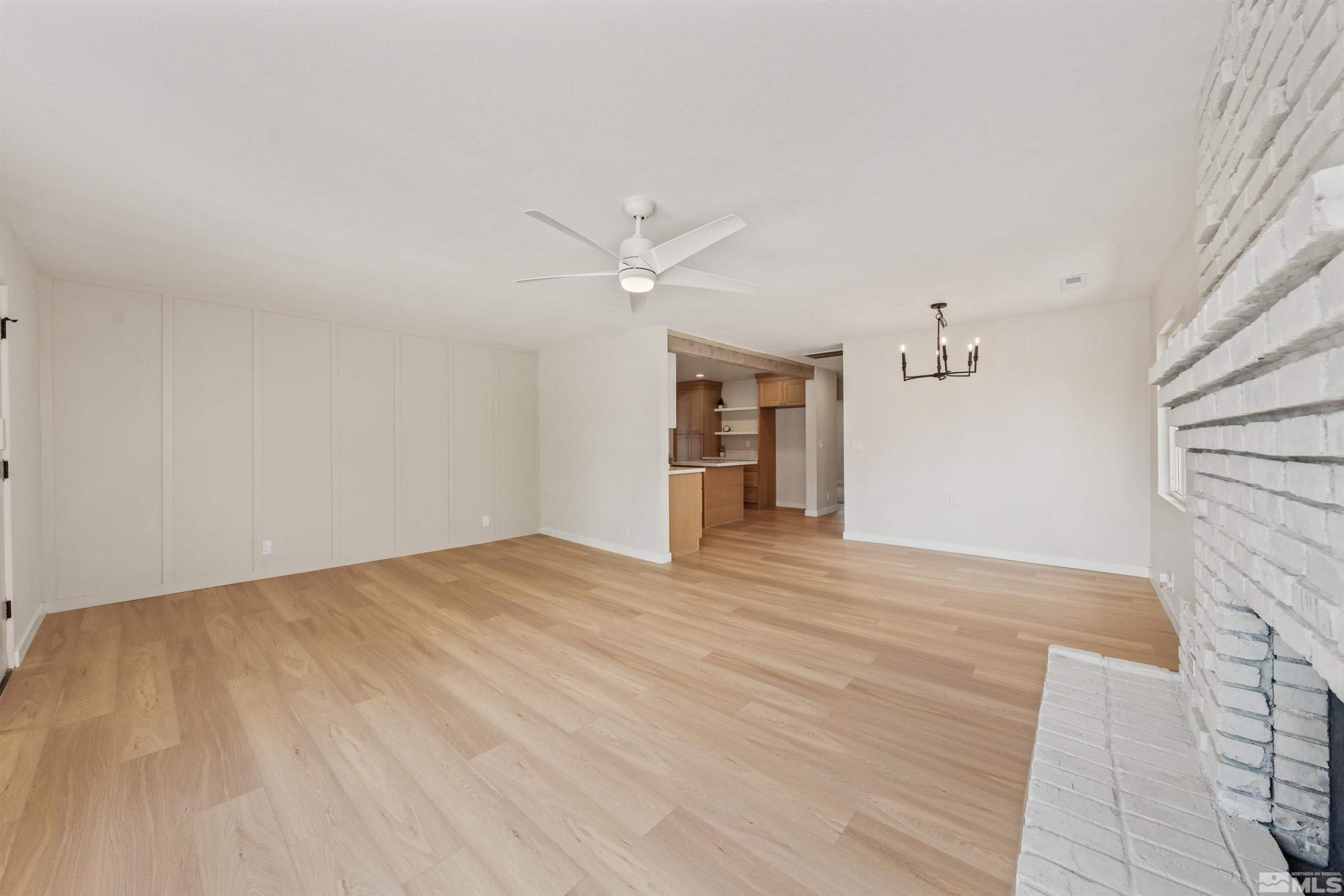 983 Melba Drive Reno, NV 89503 - Photo 8 of 39 a view of empty room with wooden floor and fan