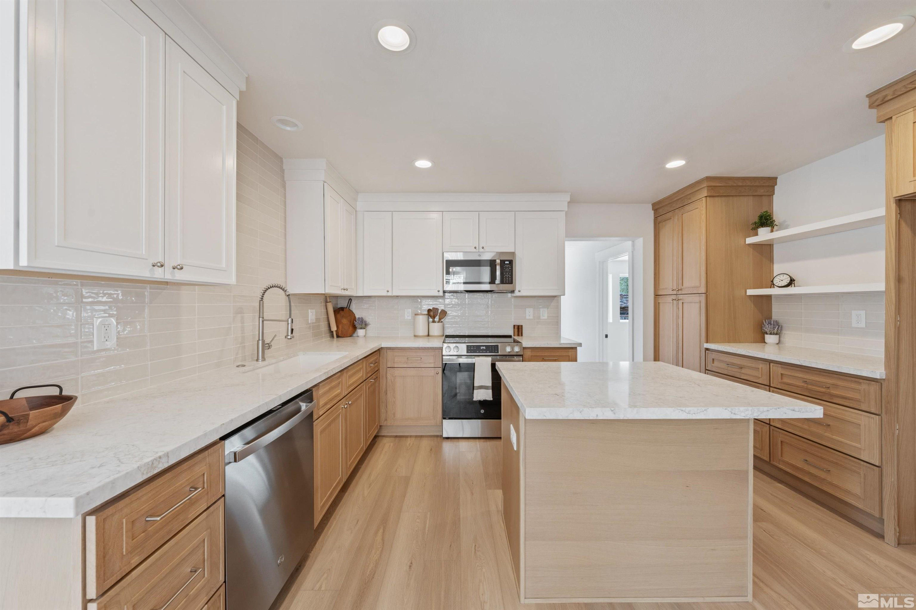 983 Melba Drive Reno, NV 89503 - Photo 10 of 39 a kitchen with stainless steel appliances granite countertop a sink stove and refrigerator