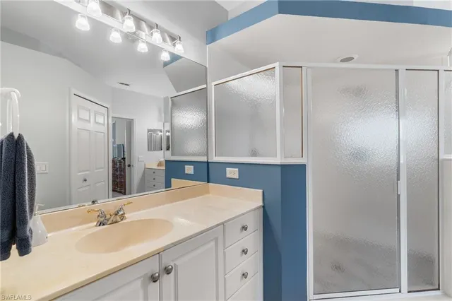 a bathroom with a sink double vanity and a mirror