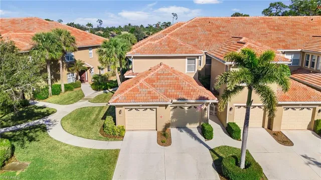 an aerial view of a house with swimming pool and furniture