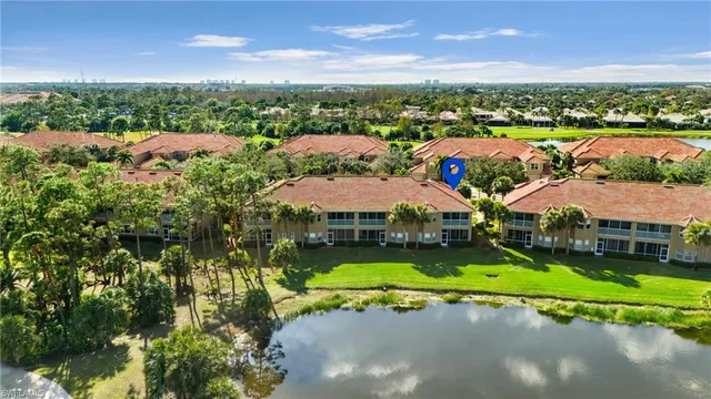 an aerial view of a house with a garden and lake view