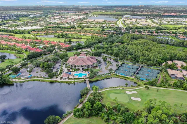 an aerial view of residential houses with outdoor space and swimming pool
