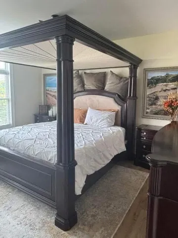 a bedroom with a bed and window