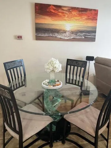 a view of a dining room with furniture wooden floor and chandelier