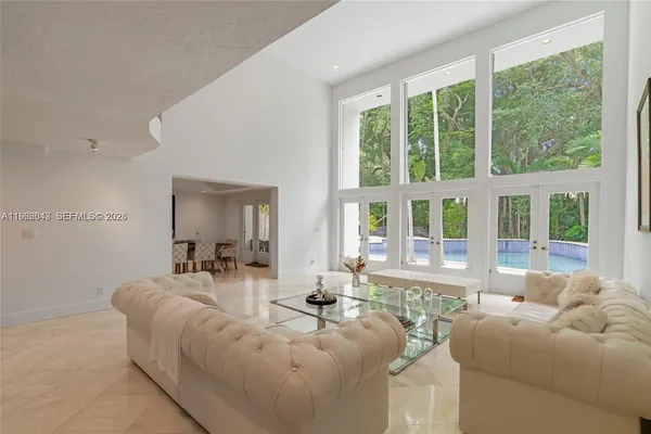 a living room with furniture and large windows