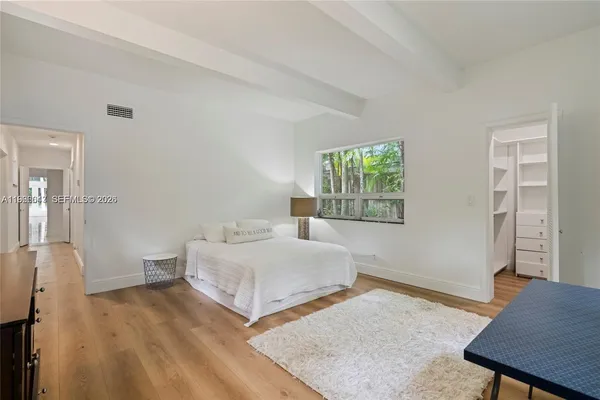a bedroom with a bed and a table in it
