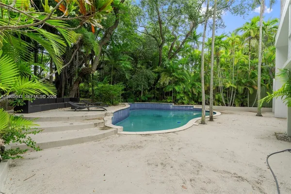 a view of a swimming pool with a backyard