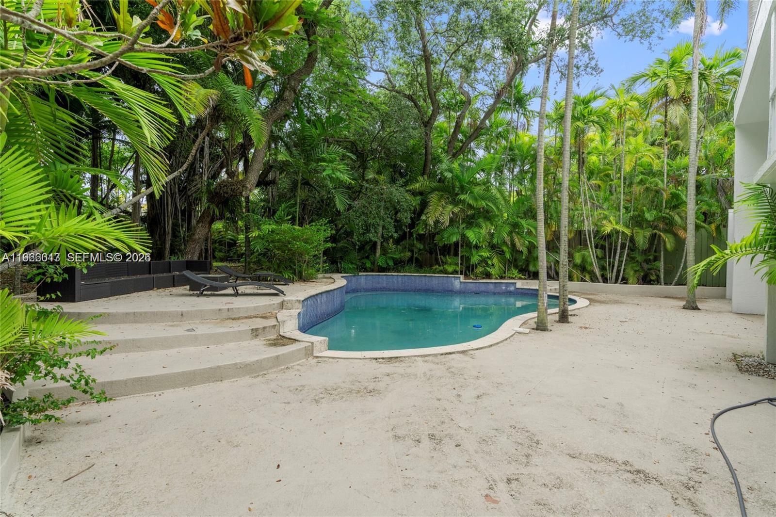 1951 Secoffee Street Miami, FL 33133 - Photo 21 of 24 a view of a swimming pool with a backyard