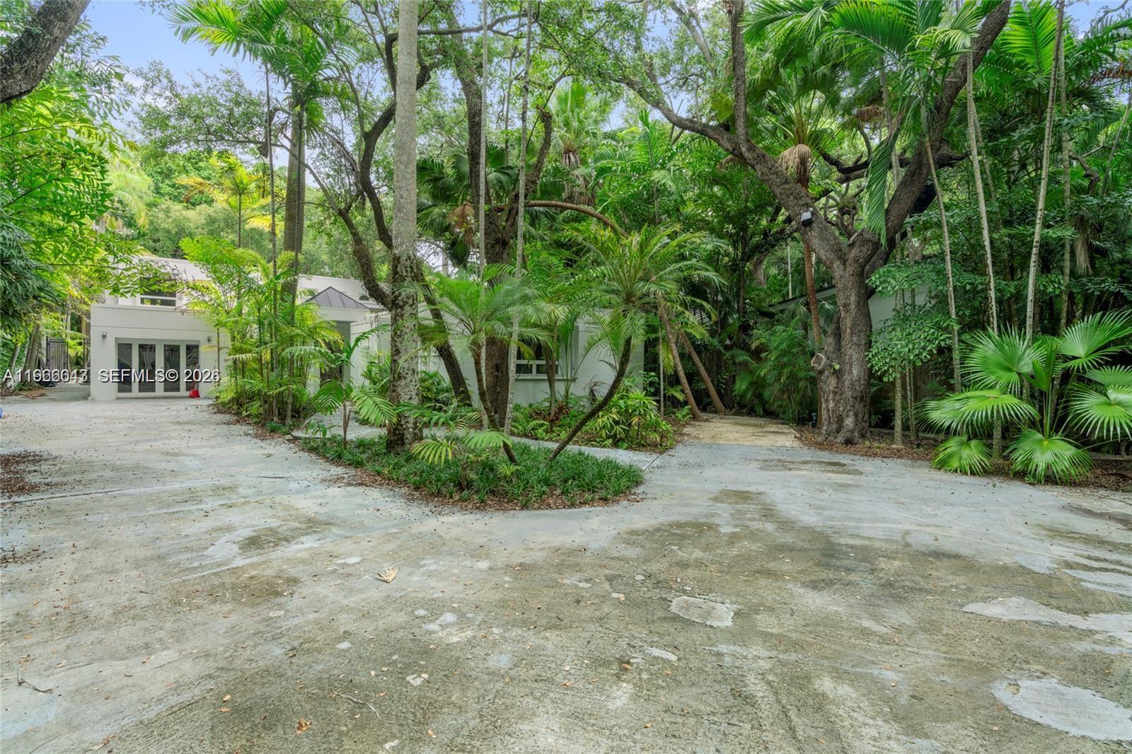 1951 Secoffee Street Miami, FL 33133 - Photo 23 of 24 a view of a yard with plants and large trees