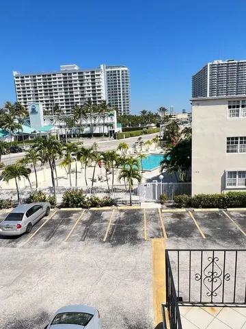 a view of swimming pool with a garden and outdoor seating