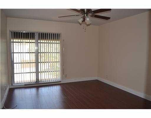2801 North 34th Avenue Hollywood, FL 33021 - Photo 4 of 9 a view of an empty room with wooden floor and a window