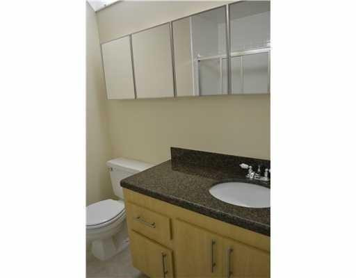 2801 North 34th Avenue Hollywood, FL 33021 - Photo 7 of 9 a bathroom with a granite countertop sink a toilet and a mirror