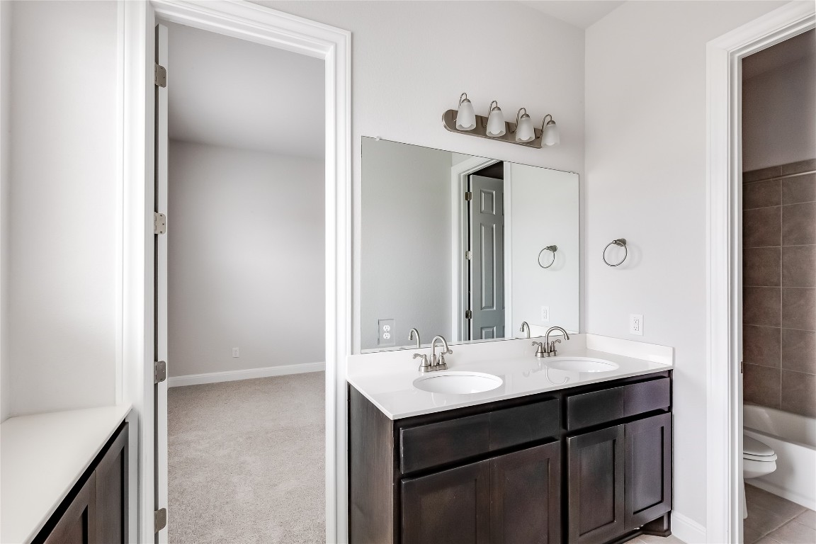 1948 Equine Road Leander, TX 78641 - Photo 27 of 36 Full bath featuring double vanity, bathing tub / shower combination, and light carpet
