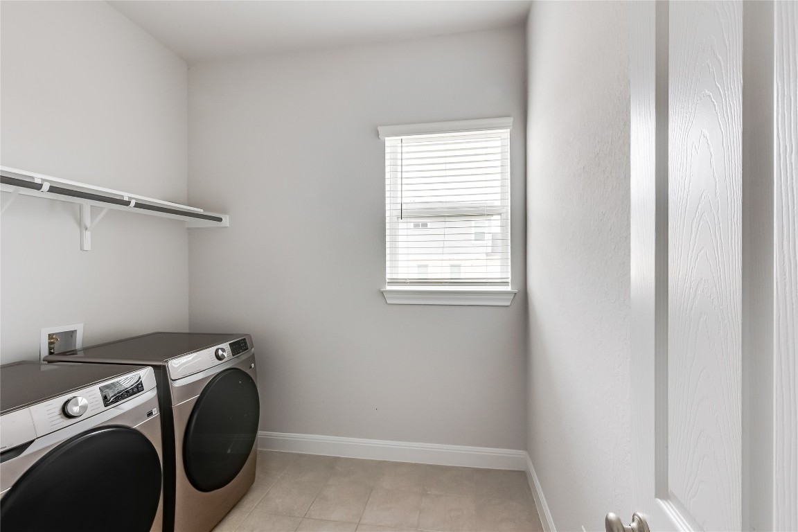 1948 Equine Road Leander, TX 78641 - Photo 31 of 36 Laundry area with washer and dryer and baseboards