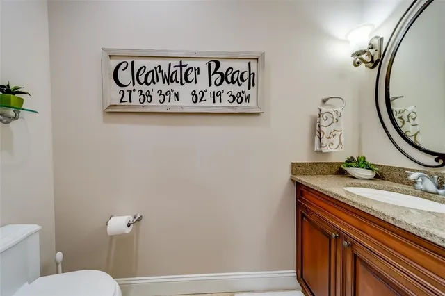 a dining room with wooden floor a chandelier a wooden table and chairs
