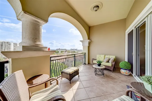 a view of a patio with dining table and chairs