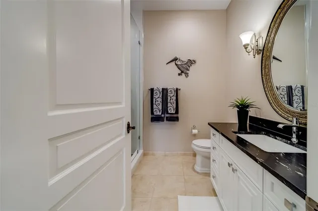 a bedroom with a bed and a flat tv screen on the dresser
