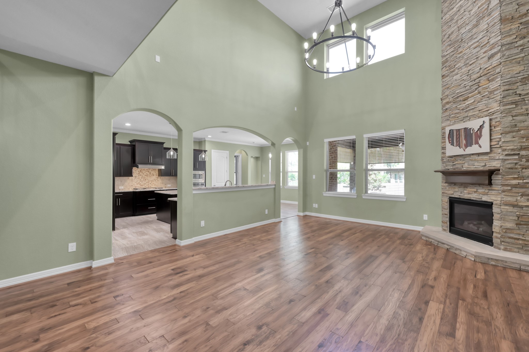 23219 Belted Kingfisher Trail Spring, TX 77389 - Photo 8 of 43 a view of a livingroom with wooden floor and a kitchen