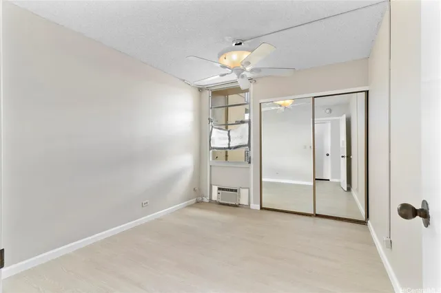 an empty room with a mirror and a shower