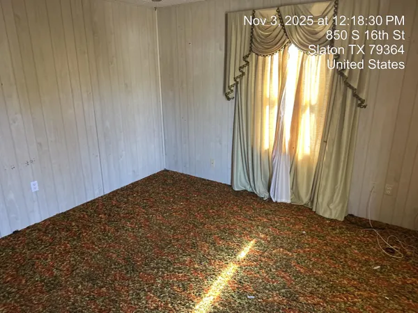 a view of an empty room and window